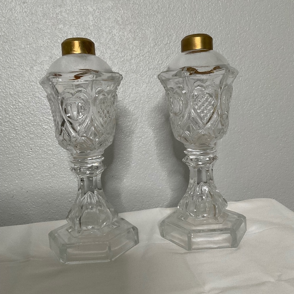 antique glass whale oil lamps, likely dating back to the mid-19th century